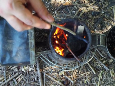 starting a bee smoker before harvesting honey hives in the farm.