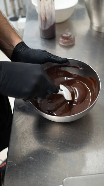 chef making for icing a drip cake in the professional kitchen lab