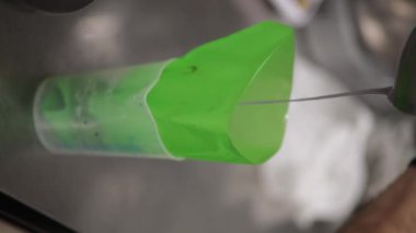 Şef, profesyonel mutfak laboratuarında leylak kremalı pasta yapıyor.