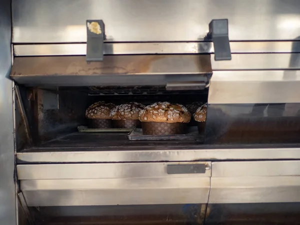 group of panettone cakes baking in the pro oven at the baker