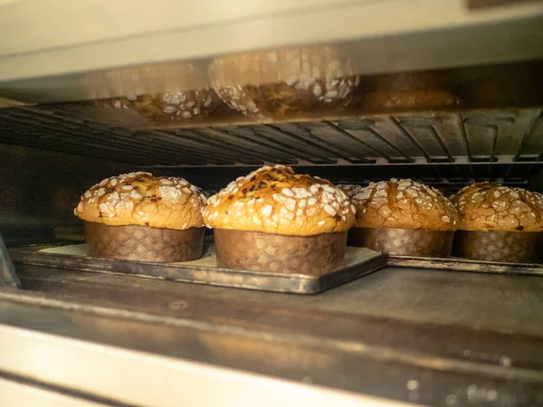 group of panettone cakes baking in the pro oven at the baker