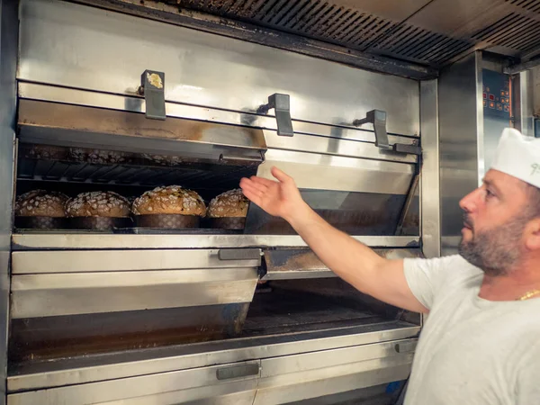 group of panettone cakes baking in the pro oven at the baker