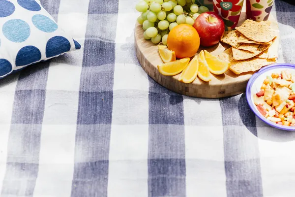 Picnic setting with fresh fruit and snacks — Stock Photo, Image