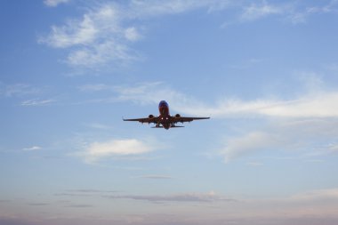 Airplane landing with pretty sky in background