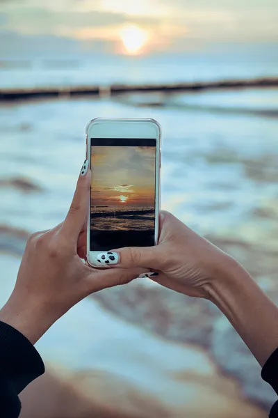 Молодая Женщина Фотографирует Закат Над Морем Помощью Смартфона Время Летней — стоковое фото