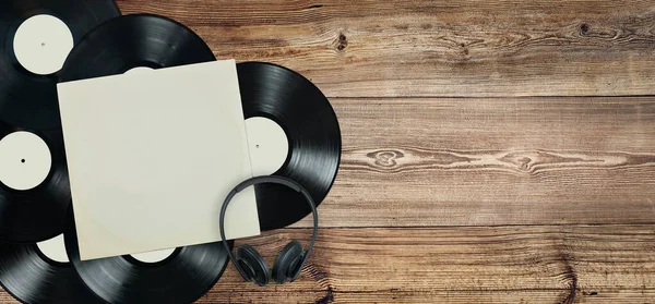 Vinyl records and on old wooden background. Records collection. Music vintage style. Classic stereo. Audio equipment. Analog sound. Old technology. Copy space right. Ready for content. Flat lay