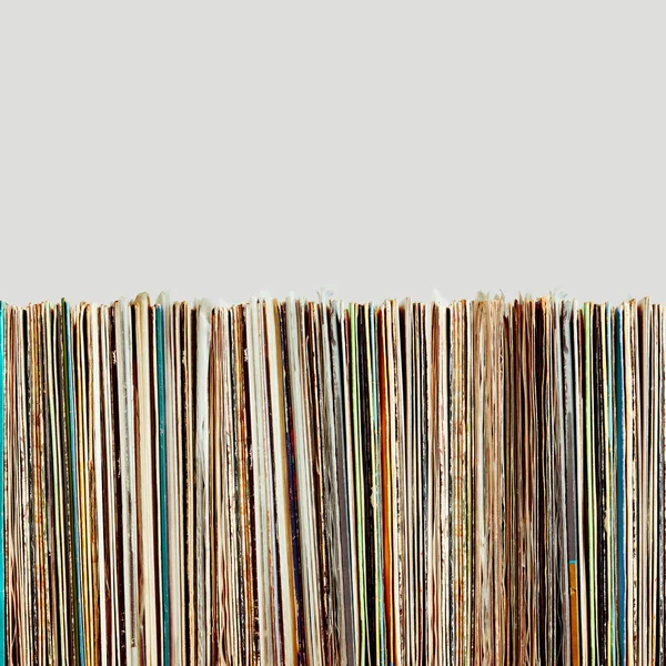 Stack of vinyl records. Listening to music from record. Playing music from analog disk. Retro and vintage. Audio stereo. Analog sound. Background with copy space. Isolated plain background
