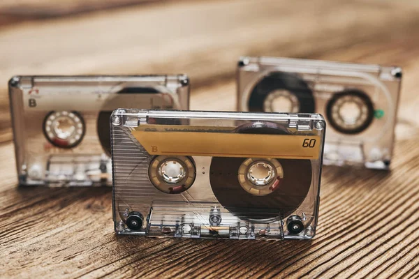 Tape cassettes. Magnetic cassette tapes on wooden table. Retro music style. 80s music party. Vintage style. Analog equipment. Stereo sound. Back to the past