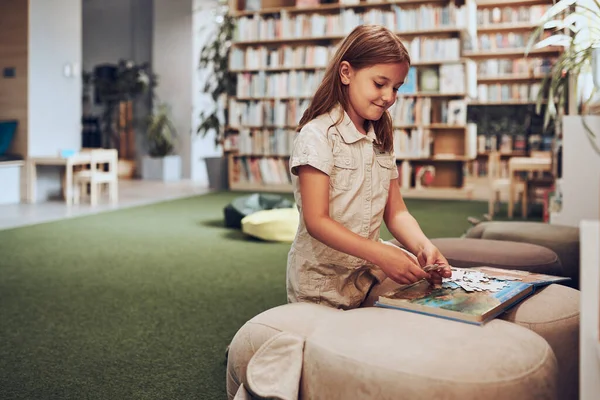 Schoolgirl Doing Puzzle Reading Book School Library Primary School Pupil — Photo