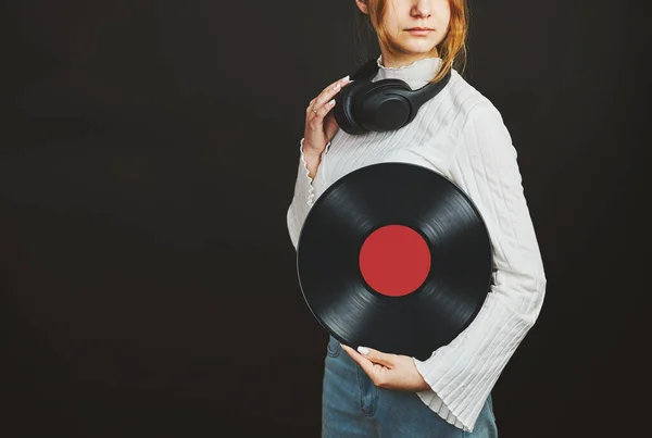 Woman holding vinyl record. Music passion. Listening to music from analog record. Playing music from analog disk on turntable player. Enjoying music from old collection. Retro and vintage. Stereo audio. Analog sound