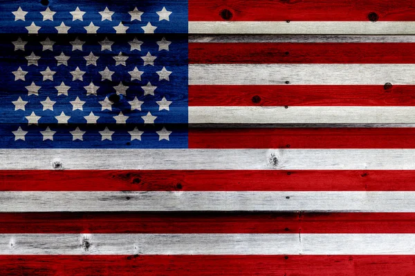 Old Painted American Flag on Dark Wooden Fence Stock Image