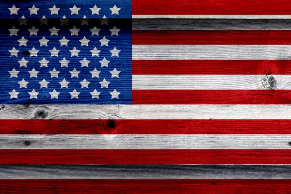 Old Painted American Flag on Dark Wooden Fence Stock Picture