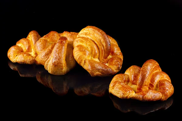 Homemade croissants, isolated on black — Stock Photo, Image