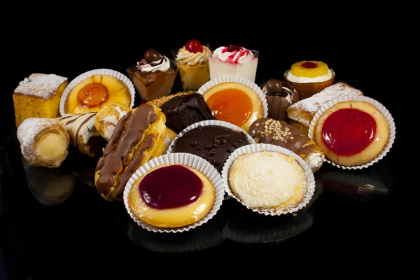 Different cakes, isolated on black — Stock Photo, Image