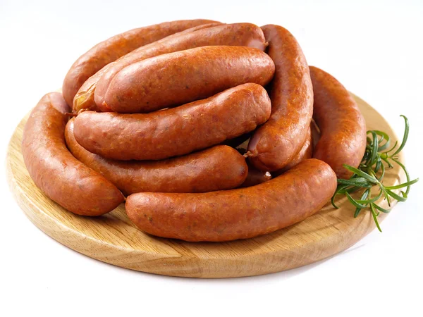 Sausages on round kitchen cutting board