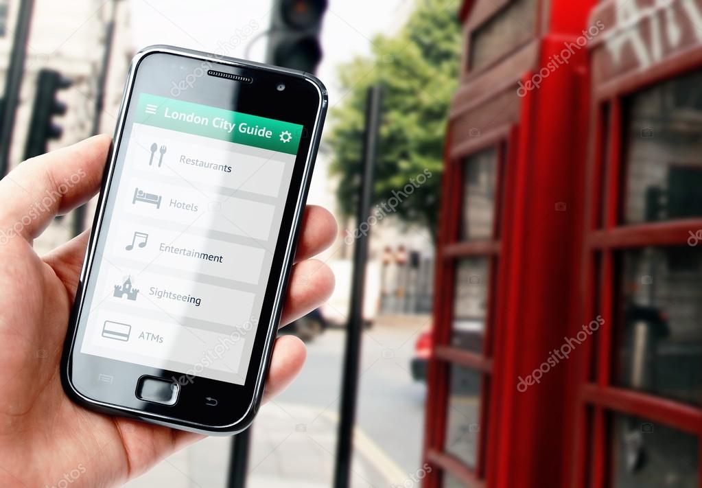 Hand holding smartphone with city guide in London