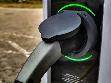 Eco electric car charging battery energy at power station