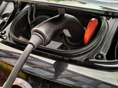 Eco electric car charging battery energy at power station