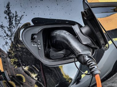 Eco electric car charging battery energy at power station