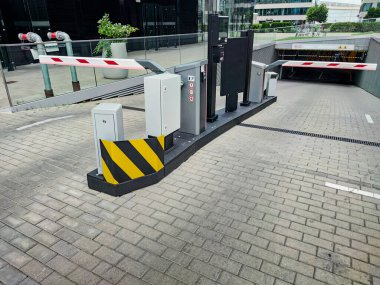 Underground garage parking entrance with boom barrier