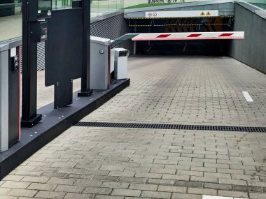 Underground garage parking entrance with boom barrier