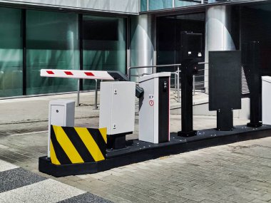 Underground garage parking entrance with boom barrier