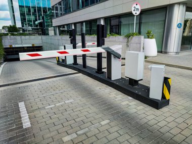 Underground garage parking entrance with boom barrier