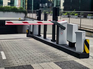 Underground garage parking entrance with boom barrier
