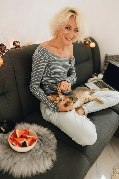 Wanita Pirang Dewasa Duduk Sofa Dan Bermain Dengan Kucing — Stok Foto