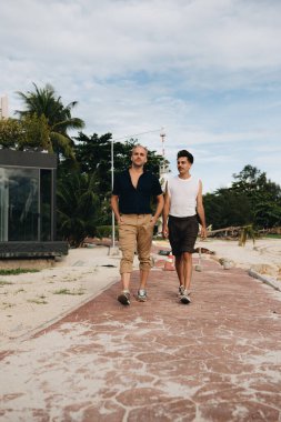 Gay Couple spend time together outdoors. Homosexual couple having fun together