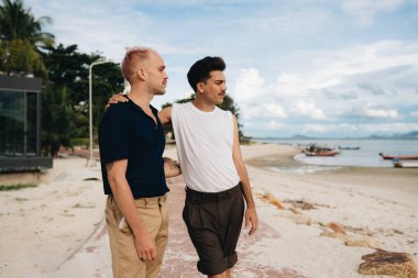 Gay Couple spend time together outdoors. Homosexual couple having fun together