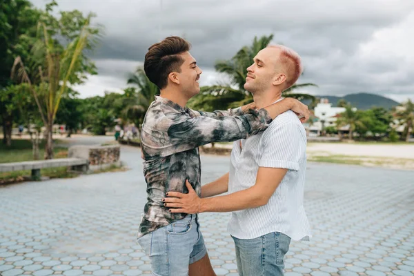 Gay Couple spend time together outdoors. Homosexual couple having fun together