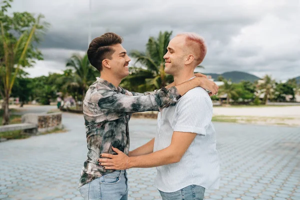 Gay Couple spend time together outdoors. Homosexual couple having fun together