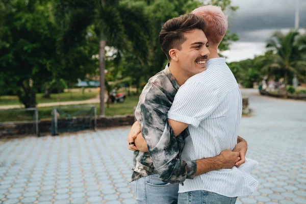 Gay Couple spend time together outdoors. Homosexual couple having fun together