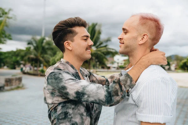 Gay Couple spend time together outdoors. Homosexual couple having fun together