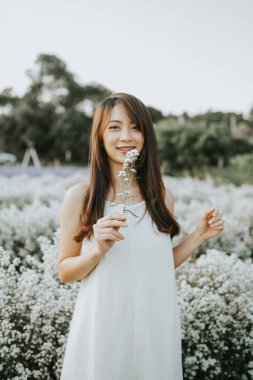 Thai woman walking in flower field