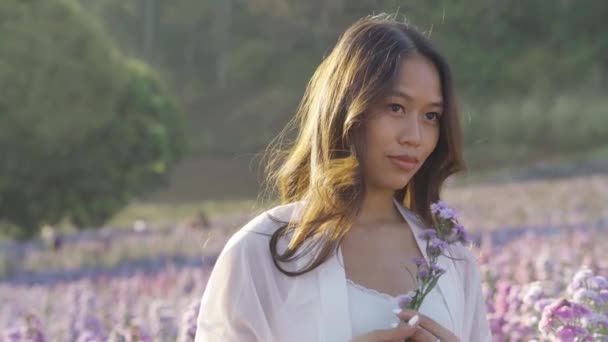 Happy Thai woman having fun in a flower field — Αρχείο Βίντεο