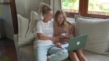 Two women browsing in laptop