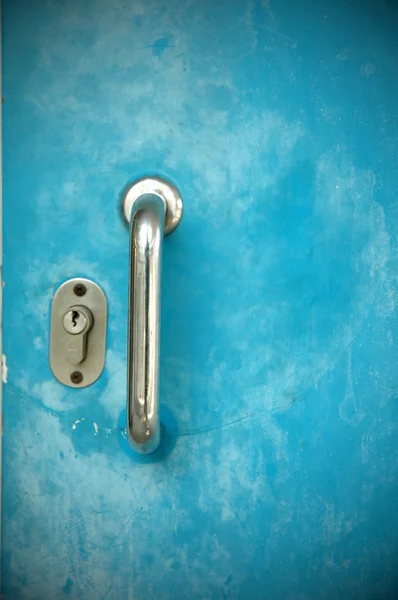 Door handles with blue metal door — Stock Photo, Image