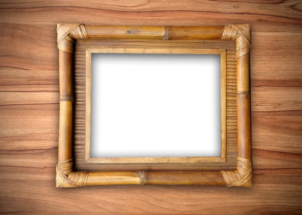 Bamboe frame op houten muur — Stockfoto