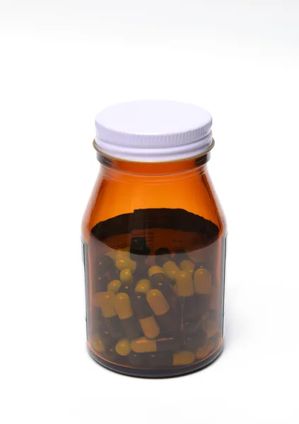 Grupo de medicamento cápsula verde em frasco — Fotografia de Stock