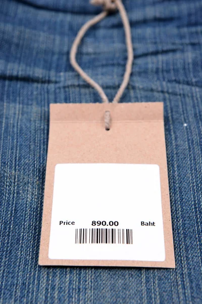 Price tag with barcode on  jeans — Stock Photo, Image