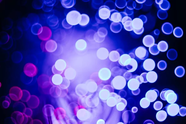 Jiskřivé abstraktní bokeh pozadí neonové barvy s třpytivými kruhy rozostřené částice — Stock fotografie