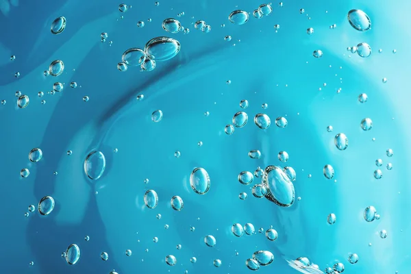 Close up macro Aloe vera gel cosmetic texture blue background with bubbles. — Stockfoto