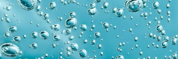 Close up macro Aloe vera gel cosmetic texture blue background with bubbles. — Stockfoto