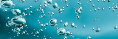 Close up macro Aloe vera gel cosmetic texture blue background with bubbles. clipart