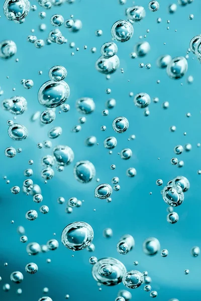 Close up macro Aloe vera gel cosmetic texture blue background with bubbles. — Stockfoto