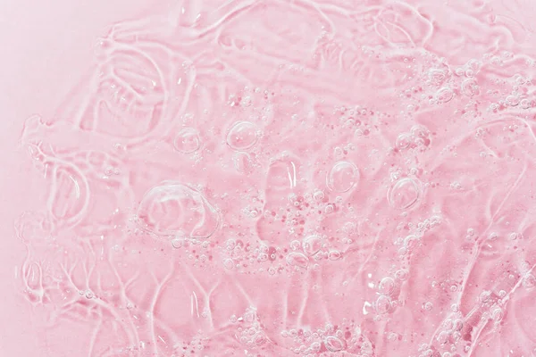 Close up macro Aloe vera gel cosmetic texture pink background with bubbles. Stock Picture