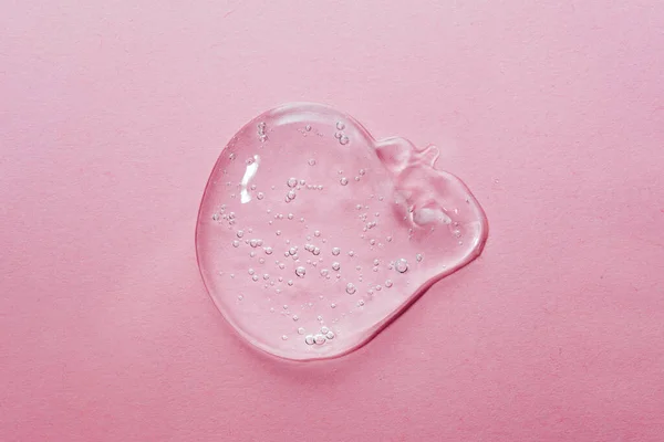Close up macro Aloe vera gel serum cosmetic texture on pink background with bubbles. — Stock Photo, Image