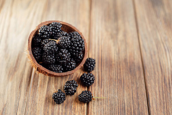 Top View Fresh Ripe Pile Blackberries Coconut Bowl Wooden Background Royalty Free Stock Images